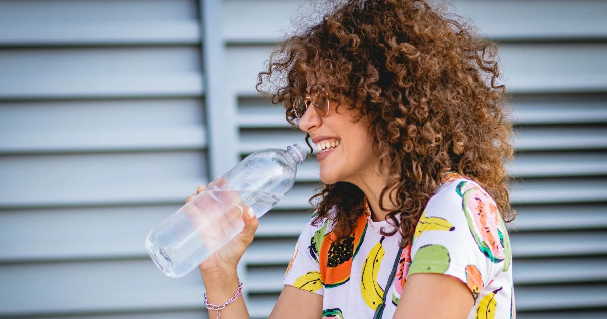 Woman drinking bottle of water.